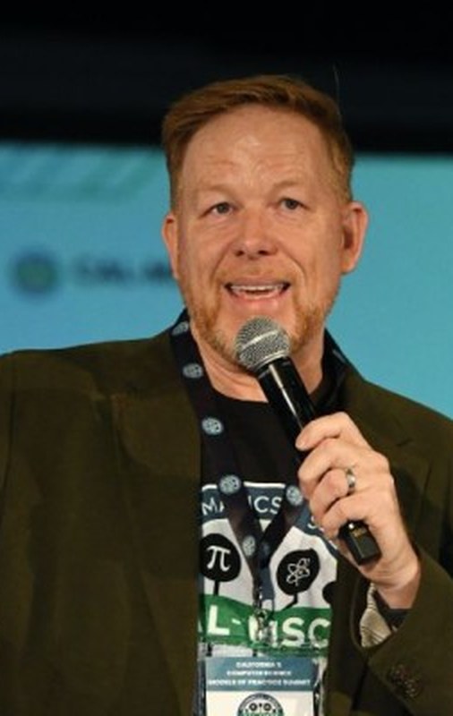 Wes Kriesel speaking with a microphone at a conference